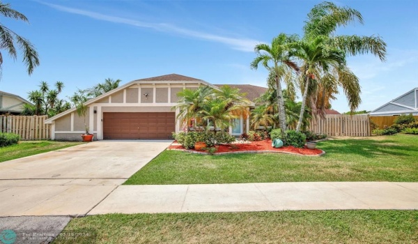 Discover the allure of this rarely available single family home with a pool in the highly desirable New River Estates located within Weston city lines, providing access to amenities like their 