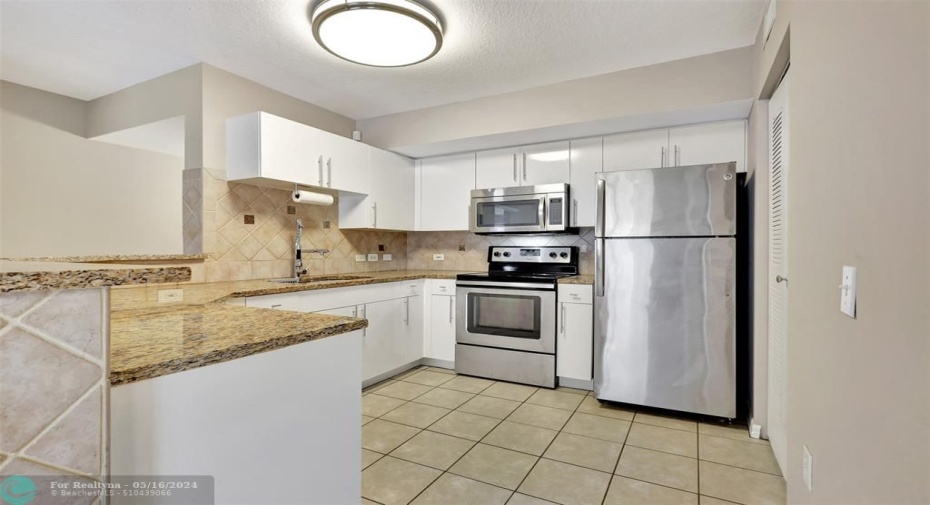 The Kitchen has beenupdated with WhiteCabinets, Granite CounterTops, and Stainless SteelAppliances