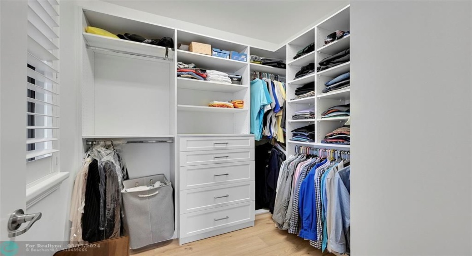 Primary Bedroom closet with custom built ins