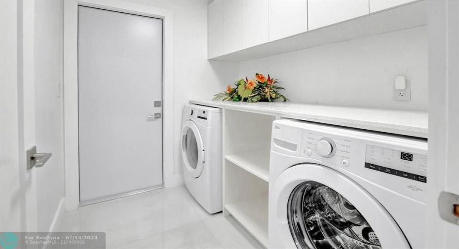 Laundry room with NEW, never used LG washer and dryer. Extra storage too!