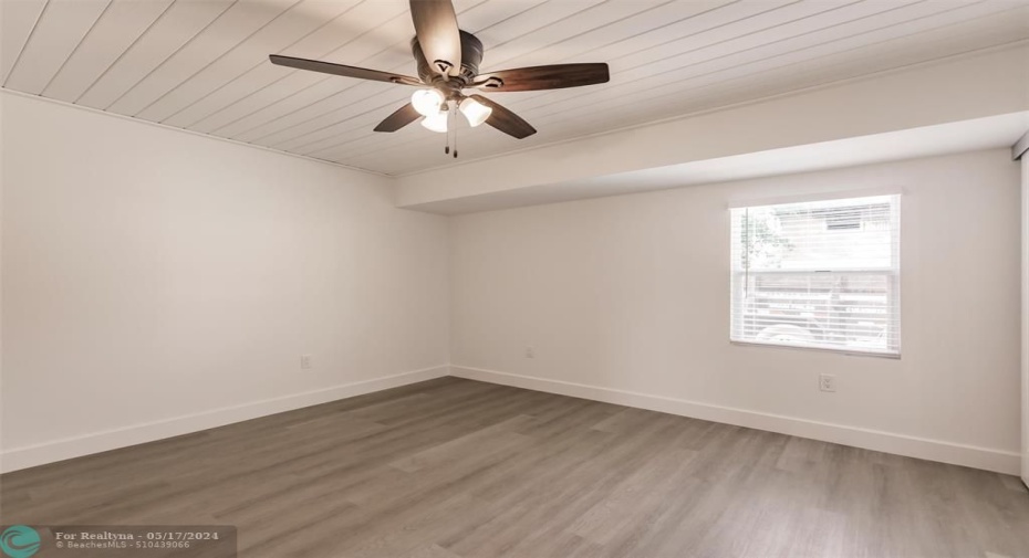 Ceiling fan in family room with front window view