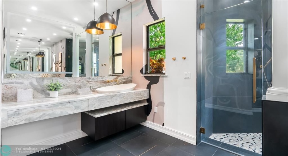 Dual sinks adjourn the Marble vanities along with individual cabinets and draws