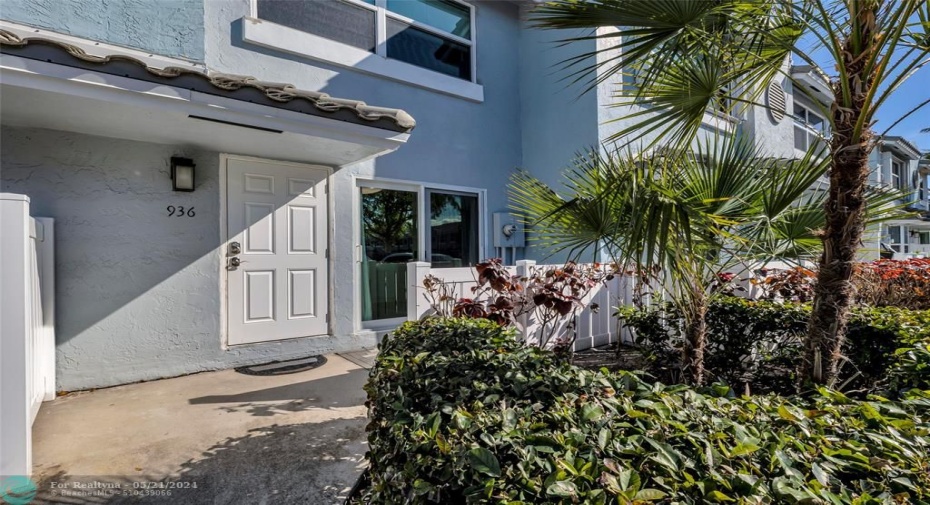 Front of townhome offers tropical landscaping