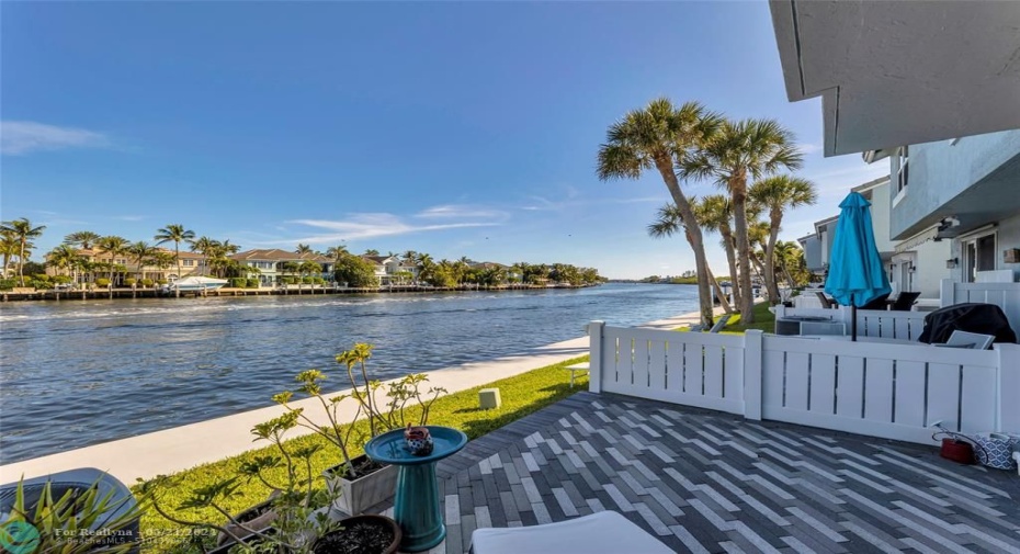Pavered patio and green space before seawall and main intracoastal