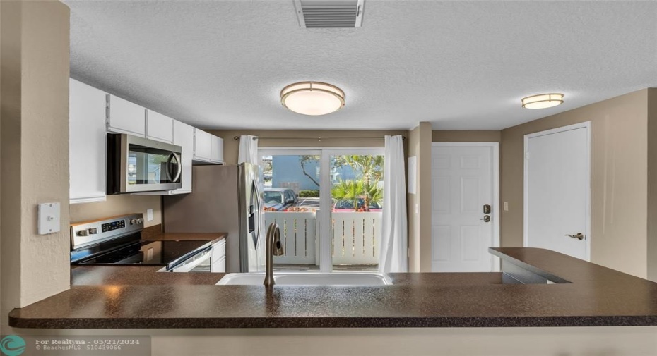 Kitchen offers open breakfast bar into dining room and has an abundance of natural light
