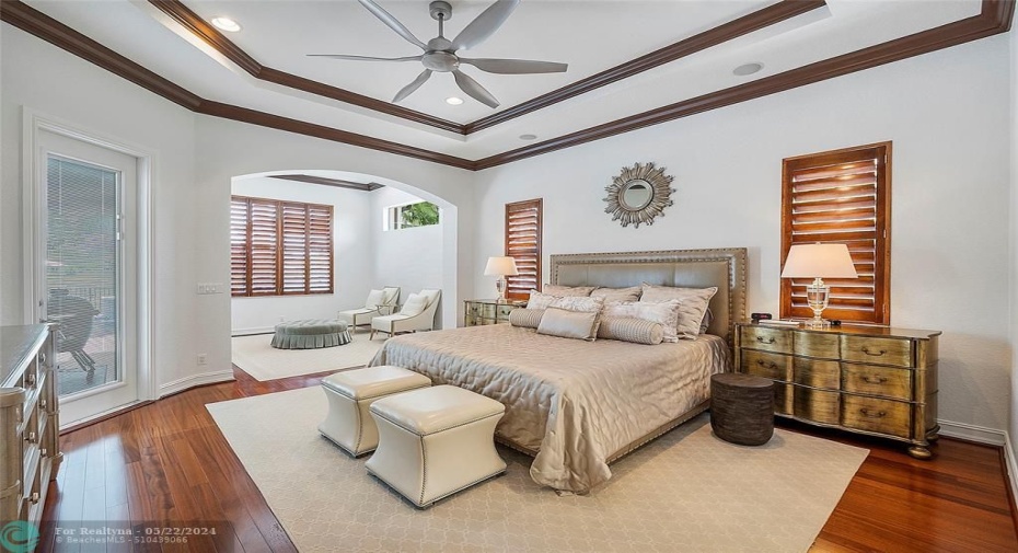 The Master bedroom suite is extended and has a private sitting room that overlooks the back pool and patio also with an outgoing door for an evening swim, Tray ceilings & real wood floors with matching plantation shutters on the windows capture the look pf paradise,