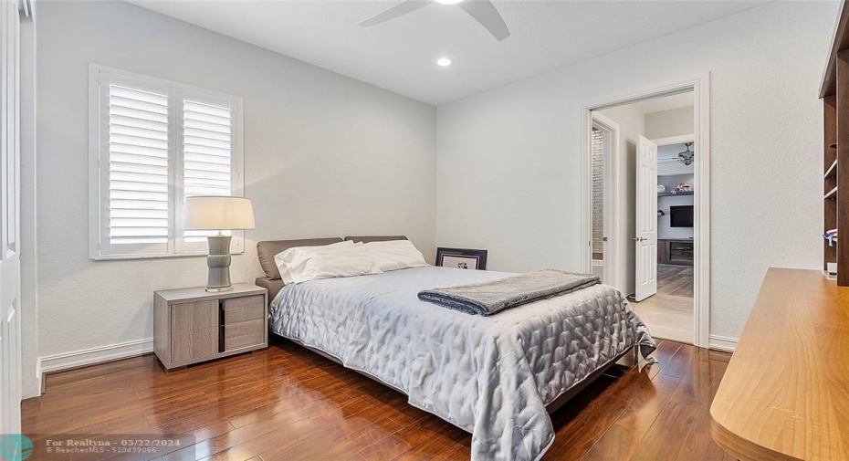 This bedroom is adjacent to the bathroom that acts like a Jack & Jill bedroom and then you move past the bathroom into another room that is a gym or fitness room  or you could use both rooms as bedrooms, plantations shutters on windows for privacy