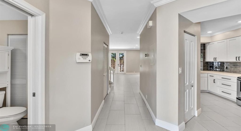 Foyer with entrances to the Kitchen on right and Guest Bathroom on left