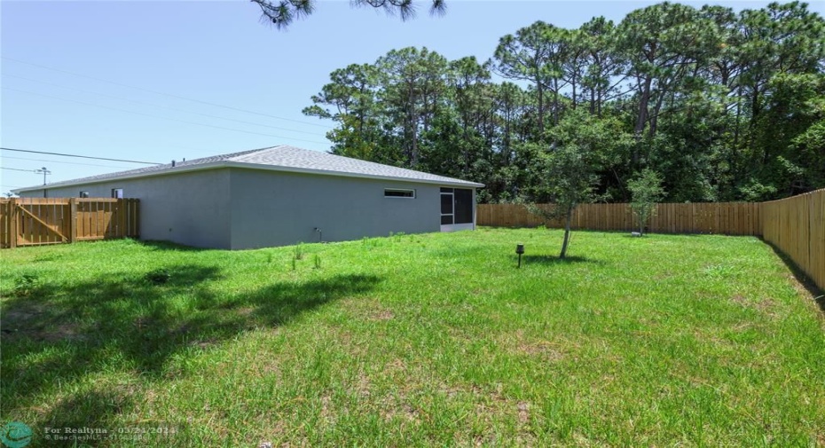 The backyard features a large screened & covered patio with a fully fenced in yard that sits on just under a ¼ acre lot offering plenty of room for pool.