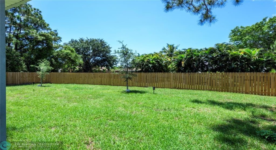 The backyard features a large screened & covered patio with a fully fenced in yard that sits on just under a ¼ acre lot offering plenty of room for pool.