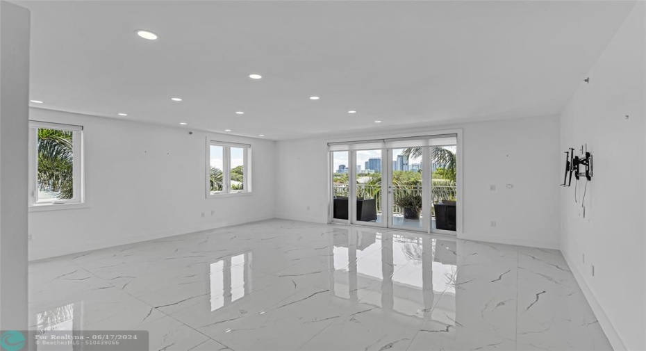 Living room with great natural light and access to large terrace with water views and the Fort Lauderdale skyline