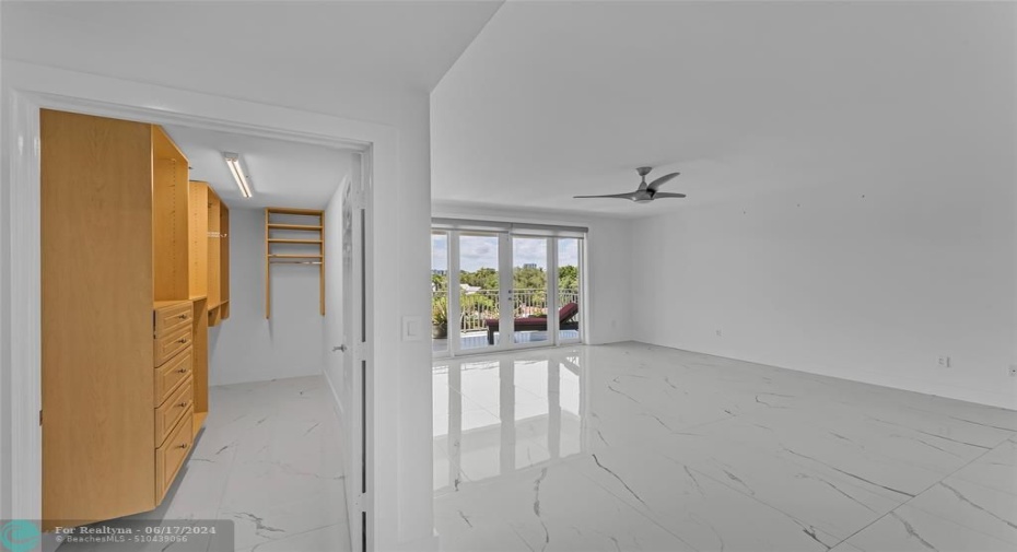 Master Bedroom with large walk in closet and French doors that lead you out to private balcony with water views