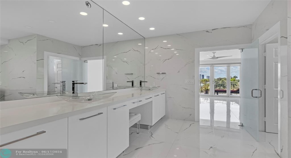 Large and spacious master bathroom with double vanity offered and marble flooring and walls