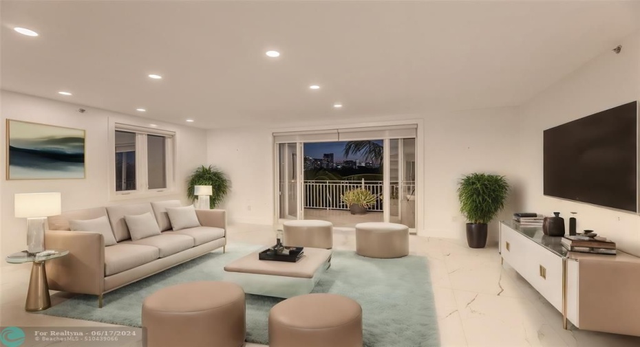 Living Room is open and spacious with sliders to patio to enjoy your water and skyline views of Fort Lauderdale - Staged photo