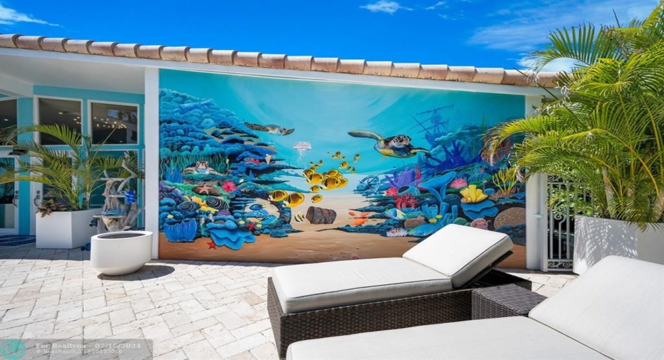 Custom Murals by Robert Rollins make this courtyard pool deck Spectacular!