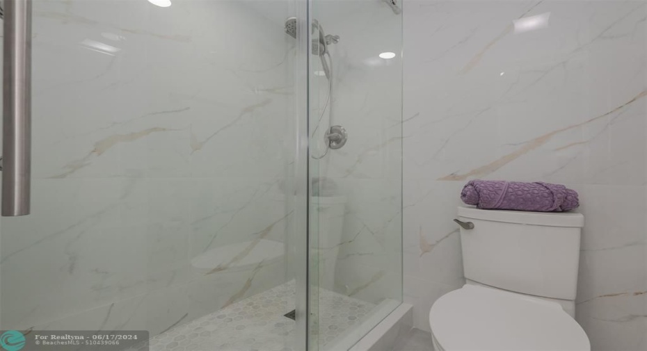ITALIAN AND SPANISH PORCELAIN TILES IN BOTH BATHROOMS. TALL HEIGHT TOILETS IN BOTH BATHROOMSTEMPERED GLASS SHOWER DOORS DELTA HYRO-RAIN TWO IN ONE SHOWER HEADS W/ 4 SPRAY PATTERNS