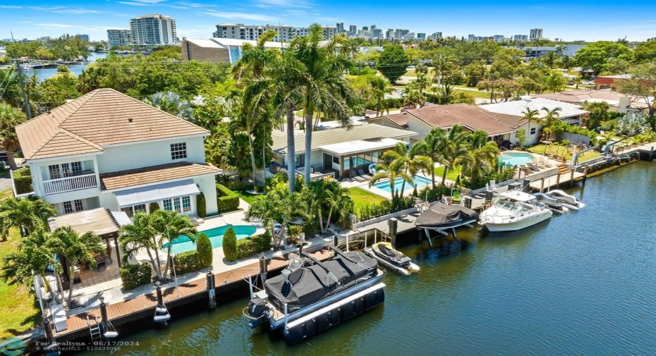 Aerial view of back exterior with dock and 15,000 lb. HydroHoist boat lift.