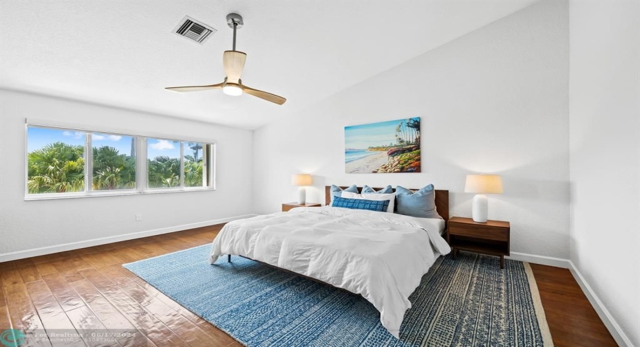 Expansive primary suite featuring dual walk in closets, vaulted ceilings and natural light