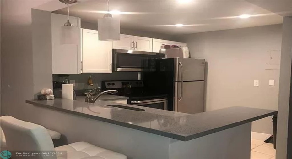 Updated Kitchen - White shaker cabinetry Quartz countertops  SS appliances -