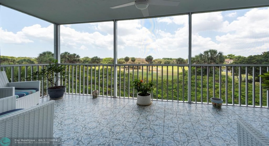 Panoramic golf view from Large approx.  18 foot wide screened balcony of the living room recently upgraded with new tile,screening & fans.