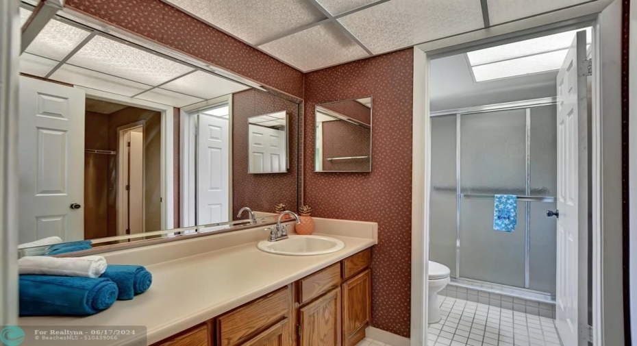 Primary bath with large vanity. Remove the wallpaper and you are good to go!