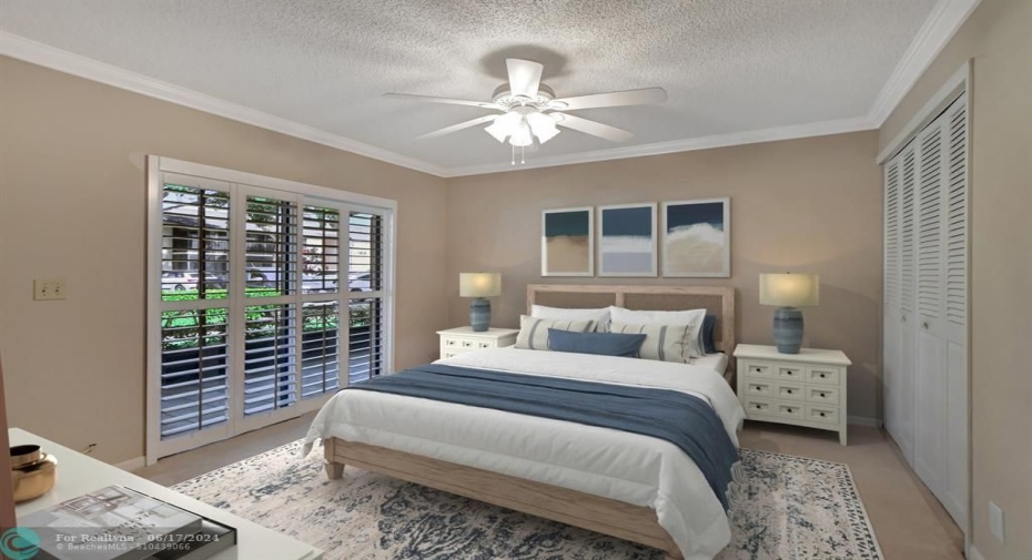 Spacious guest bedroom with pretty Plantation shutters.