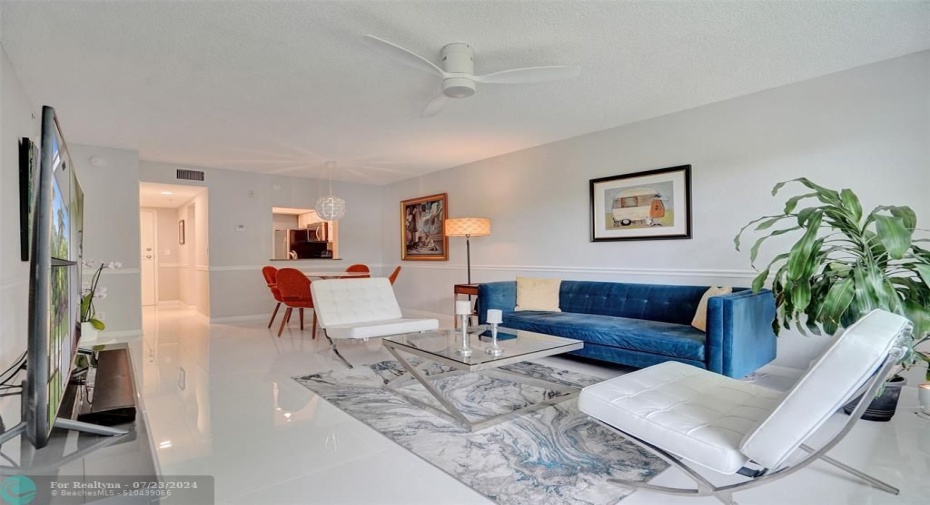 Open-concept living/dining area with porcelain tile floors