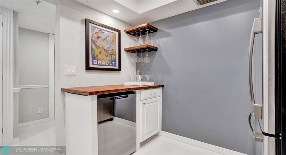 Custom-designed bar with wine fridge and acacia wood top