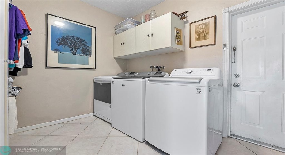 Giant laundry room with closet and 3 car garage access