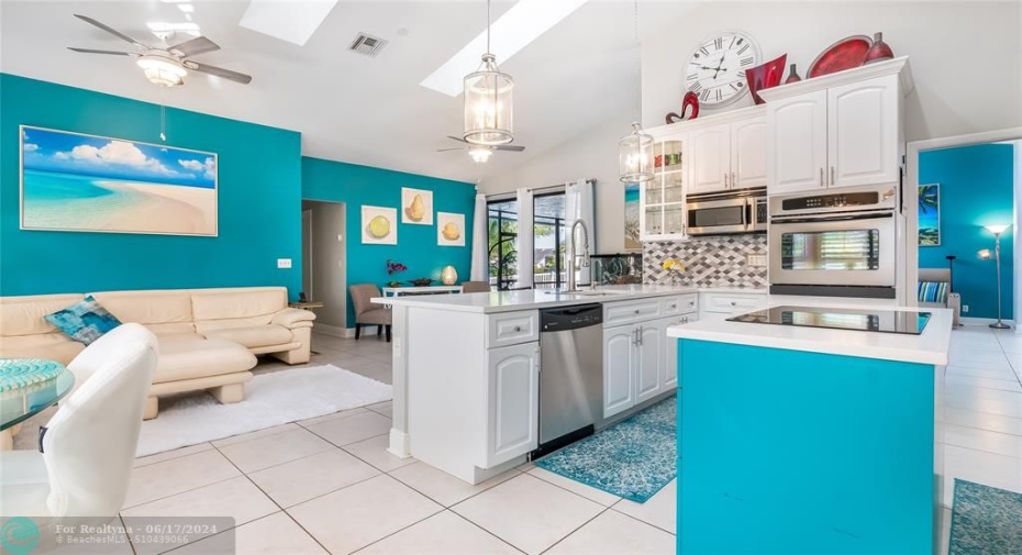 An entertainer's dream layout that cultivates togetherness - whip up culinary creations at the sprawling breakfast bar while socializing with loved ones. Enjoy natural light through skylights and the abundance of windows.