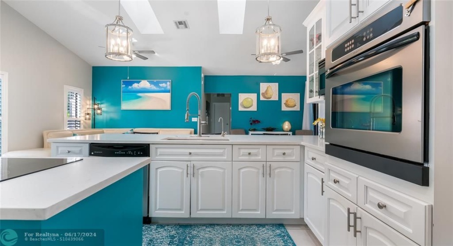 Experience the culinary-minded functionality of this thoughtfully designed kitchen. The cooktop island is accessible from all sides, allowing for seamless movement. Meanwhile, the wall-mounted oven can be used without disrupting the prepping efforts on the wrap-around granite countertops.