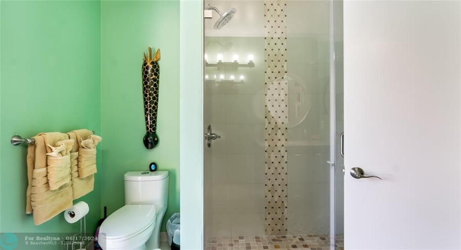 Notice the beauty of the seamless glass shower.