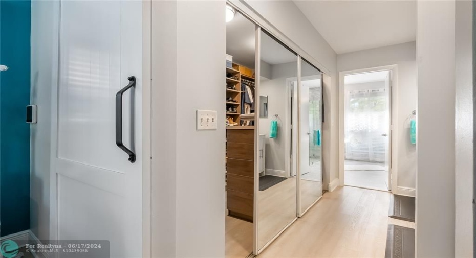 Just steps away, the exceptional custom-fitted walk-in closet showcases built-in shelving, drawers, and hanging rods to accommodate even the most extensive wardrobe and accessories
