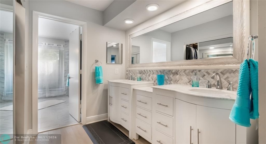 Dual vanities offer ample countertop space and storage.