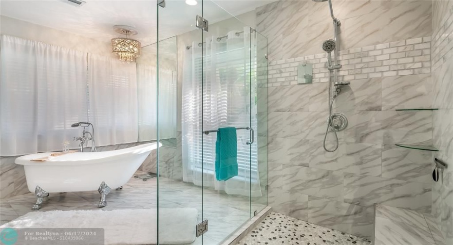 Soak away stress in the freestanding soaker tub positioned by a private view window.