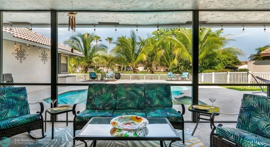 The covered patio truly recaptures the essence of cherished Florida living - embracing indoor/outdoor harmony against a private, scenic backdrop.