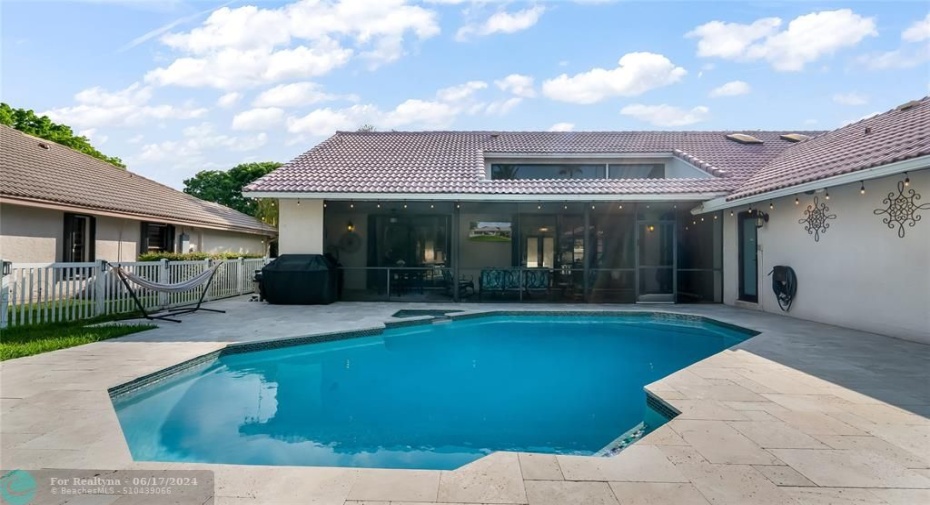 Ample deck space surrounds the pool, offering plenty of room for lounging and alfresco dining.