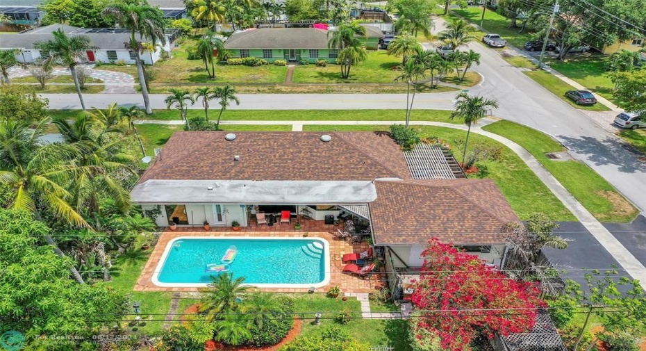 Aerial view of home, pool, yard, landscaping and lot