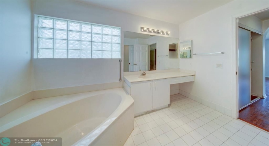 Your master bath has a large separate tub and double vanity.