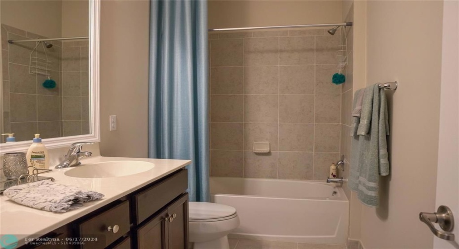 The upper guest bath has the tub-shower combo.