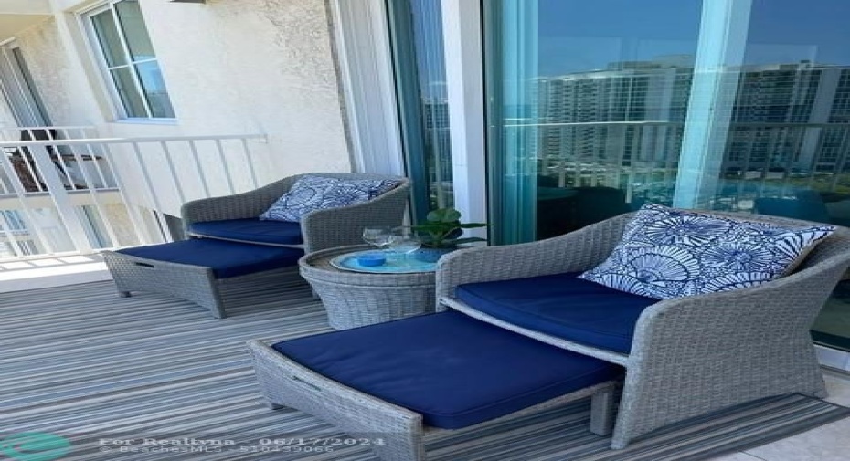 Relax on your large balcony with wide open city and ocean views