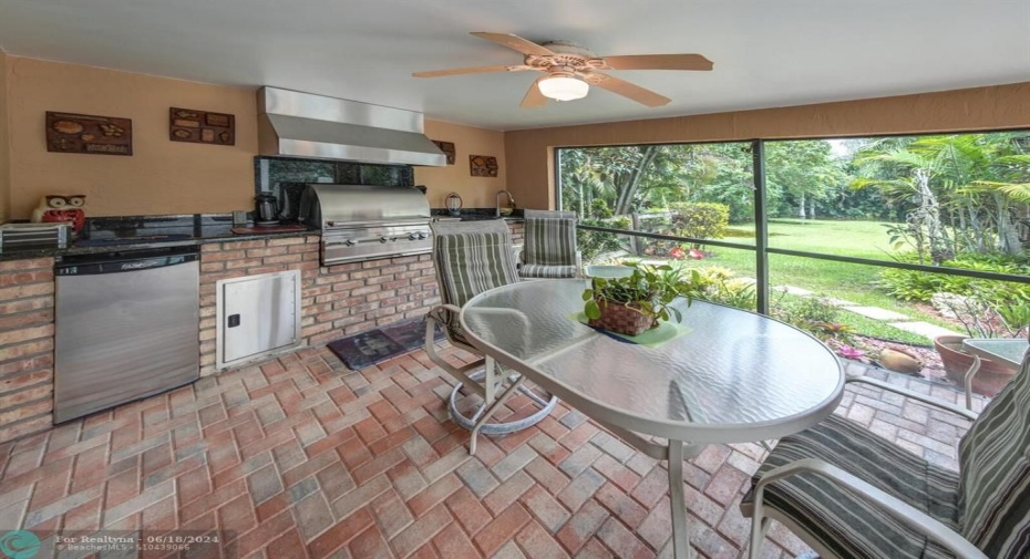 Fabulous summer kitchen in enclosed patio, with gorgeous landscaping as far as the eye can see.