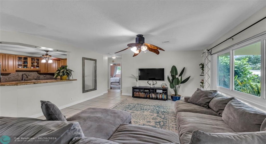 Living Room offers an abundance of natural light and opened to kitchen with large breakfast bar