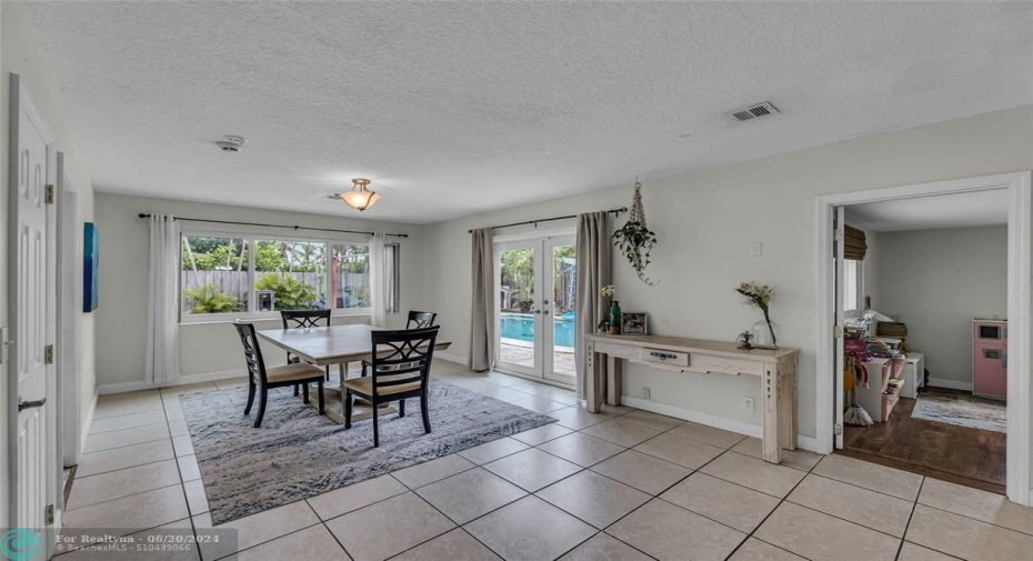 Large and spacious dining room with access to backyard from French doors