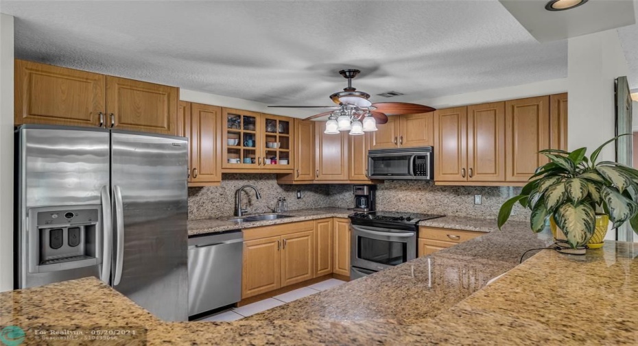 Kitchen is open with great storage space and stainless steel appliances