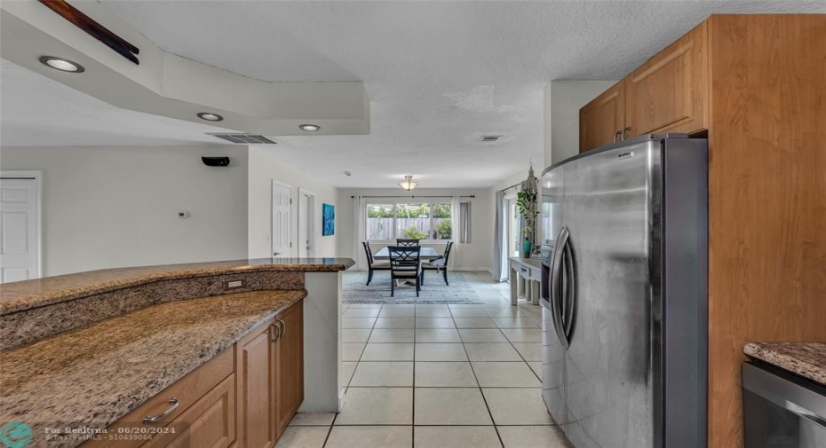 Kitchen is open to dining room and living room with an abundance of counter space