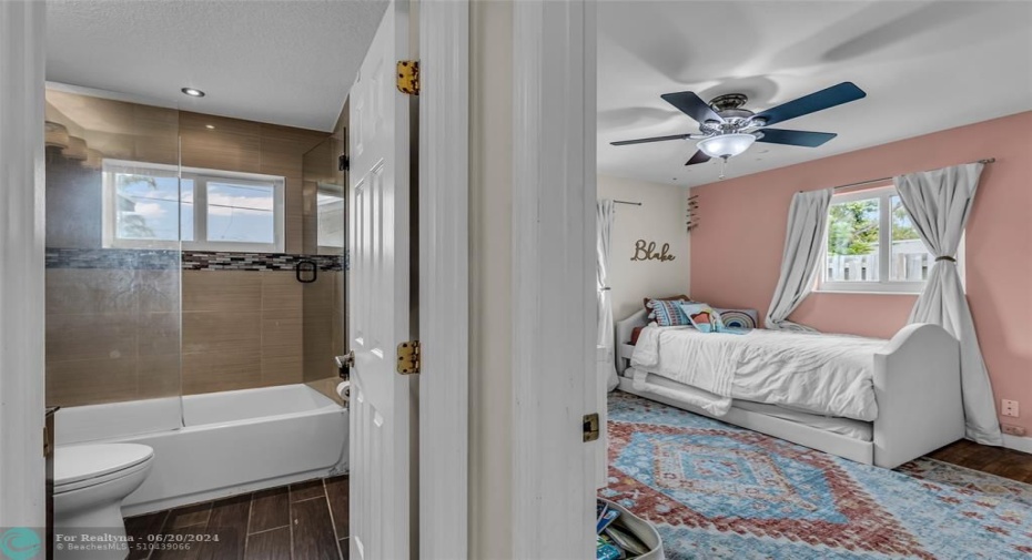 Full bathroom with tub / shower combo and second bedroom