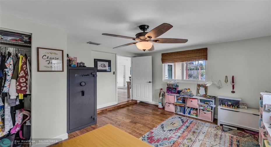 Spacious master bedroom with overhead ceiling fan with lighting