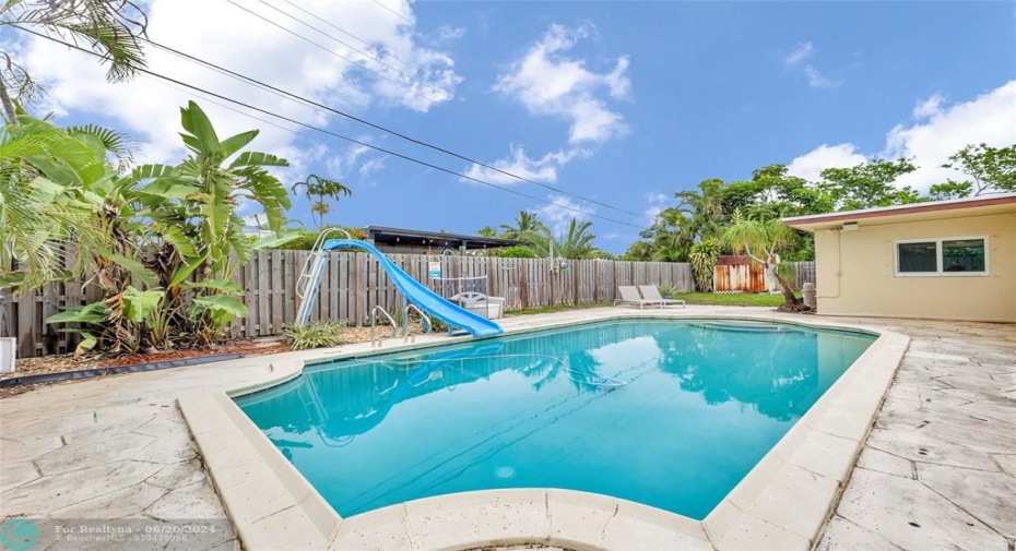 Enjoy this pool with slide in your private fenced backyard in Deerfield Beach