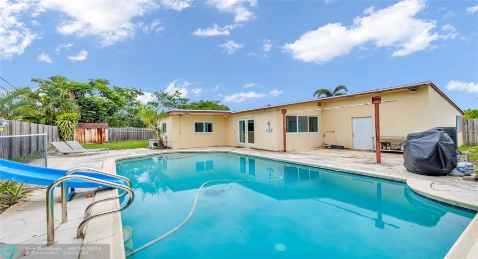 enjoy entertaining in this great backyard with pool and slide